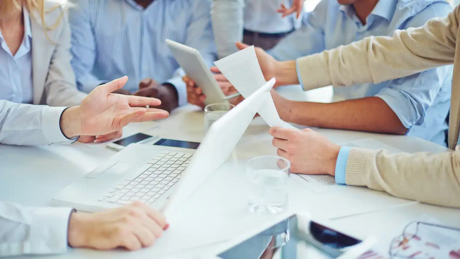 Team members reviewing performance documents and data during a collaborative meeting—representing modern culture-based performance evaluation in the workplace.