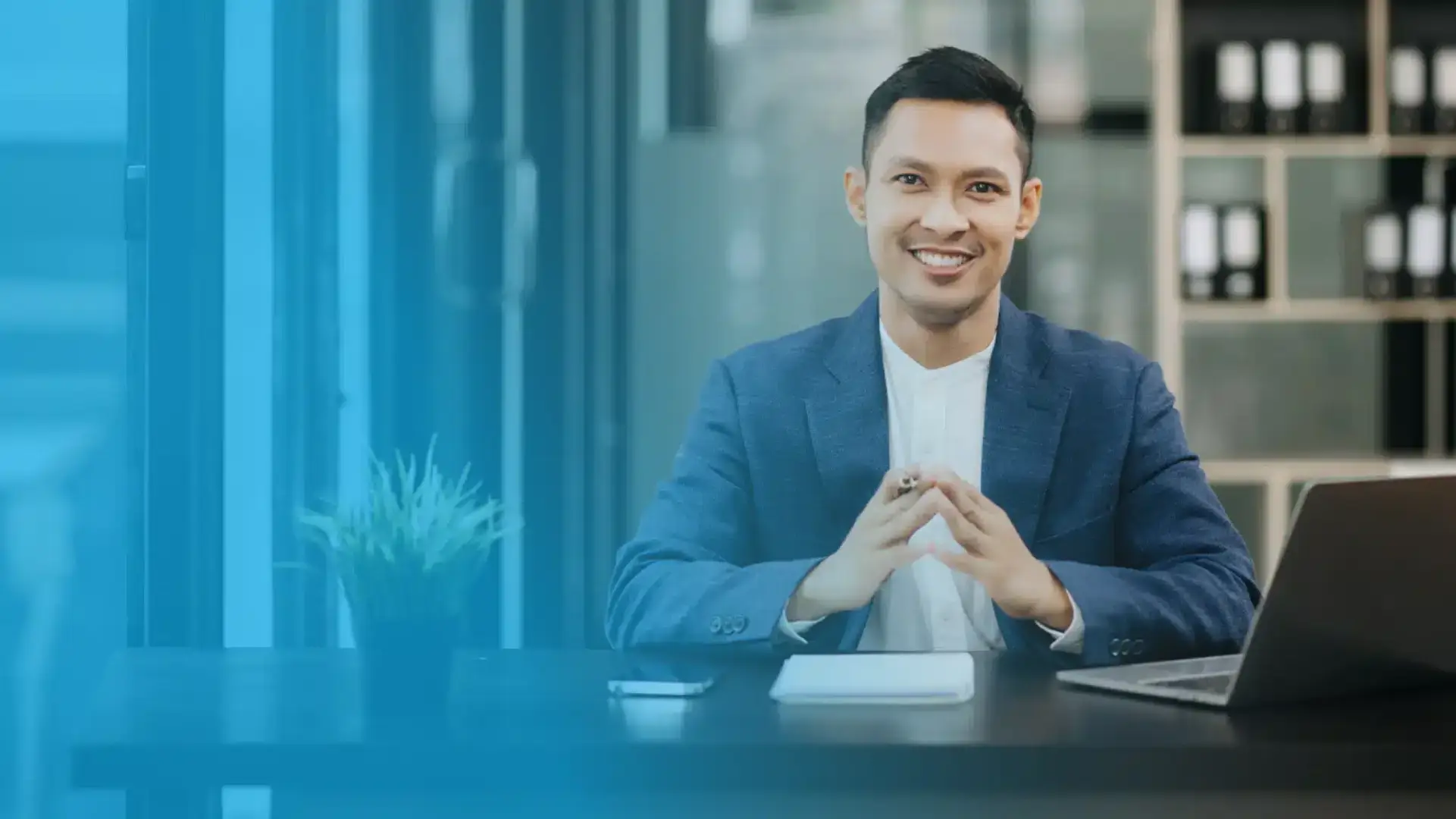 A confident HR professional sitting at a desk, symbolizing the efficiency of a smart and automated HR platform in modern workforce management.